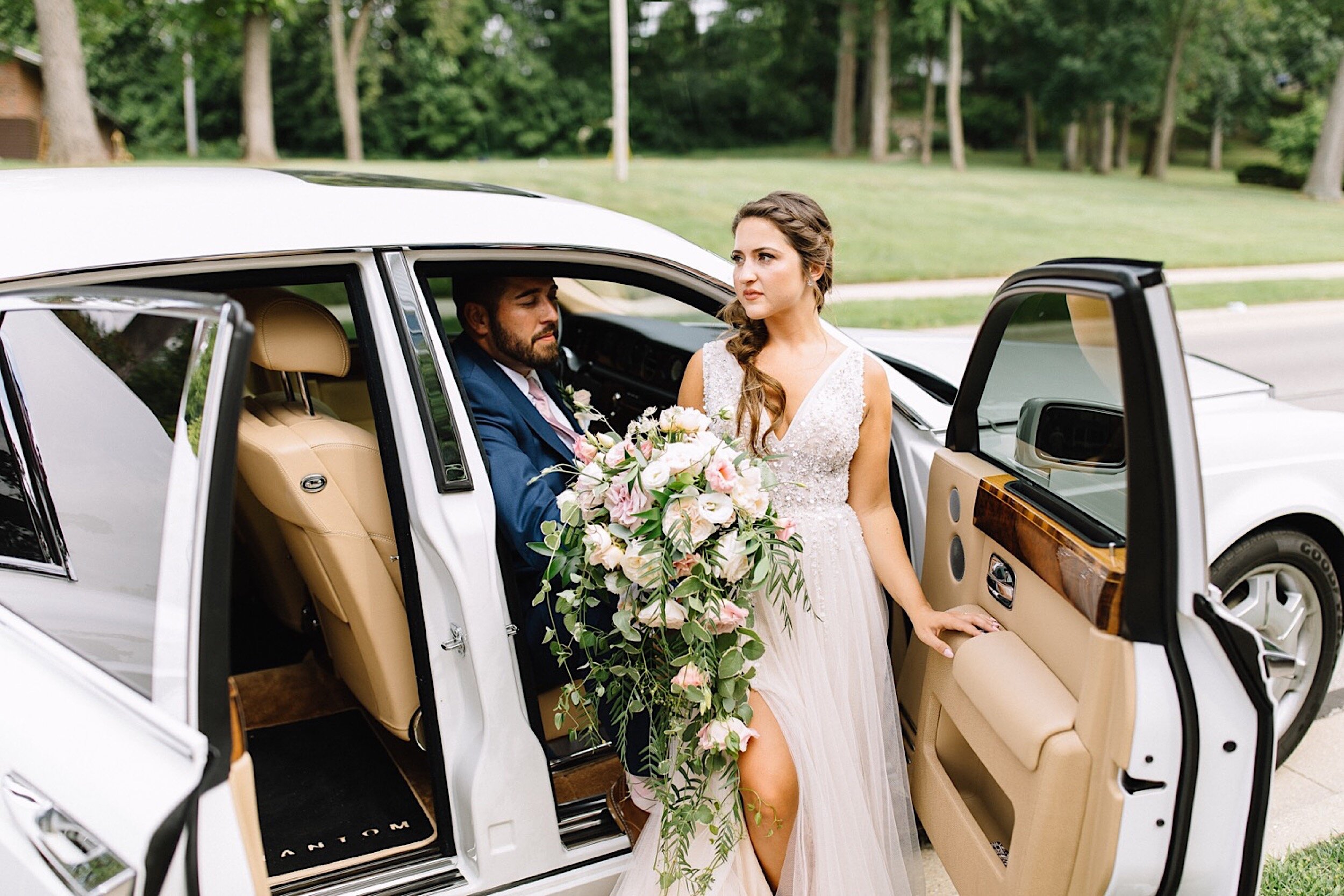 bride and groom in a rolls Royce