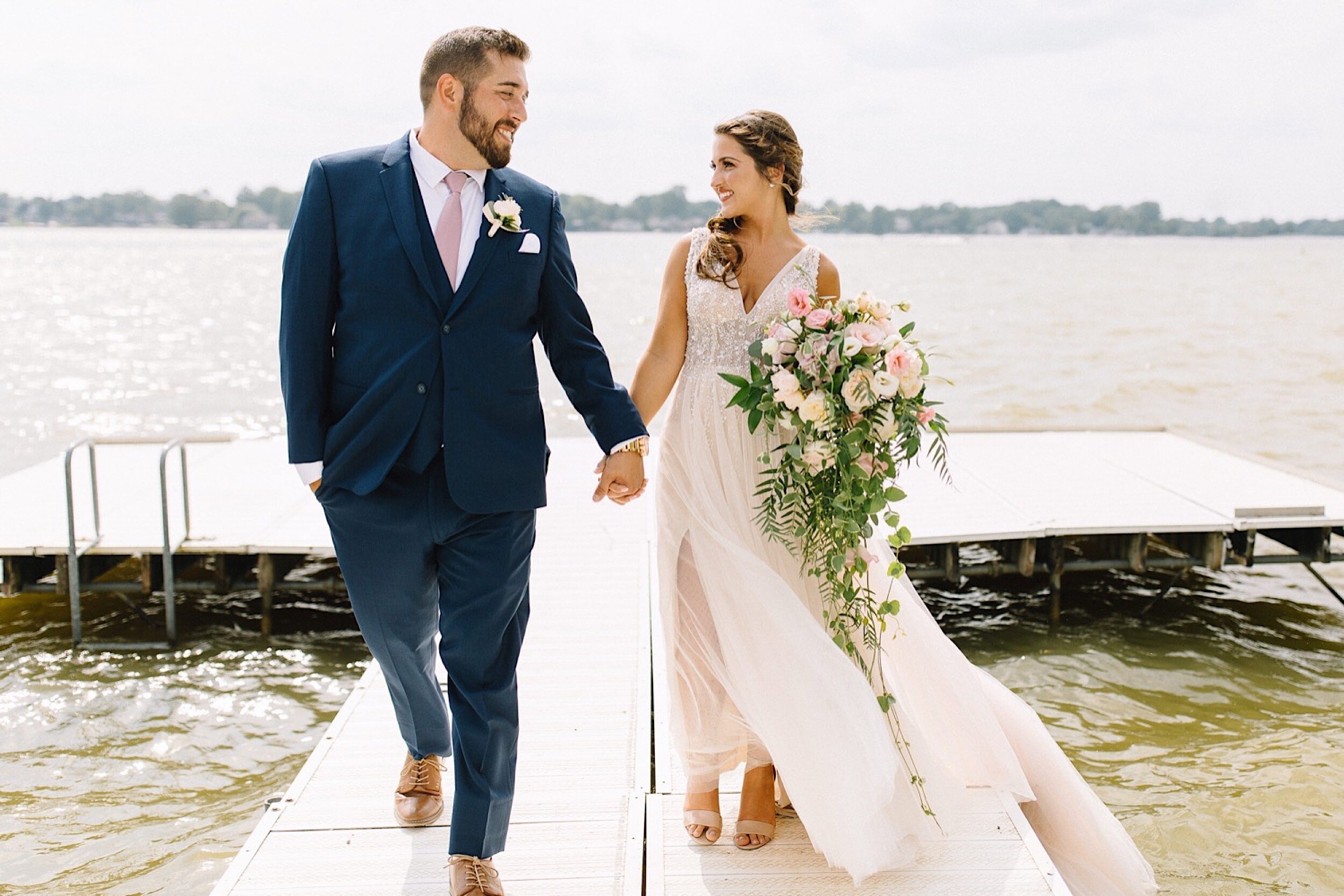 bride and groom on dock in Winona Lake